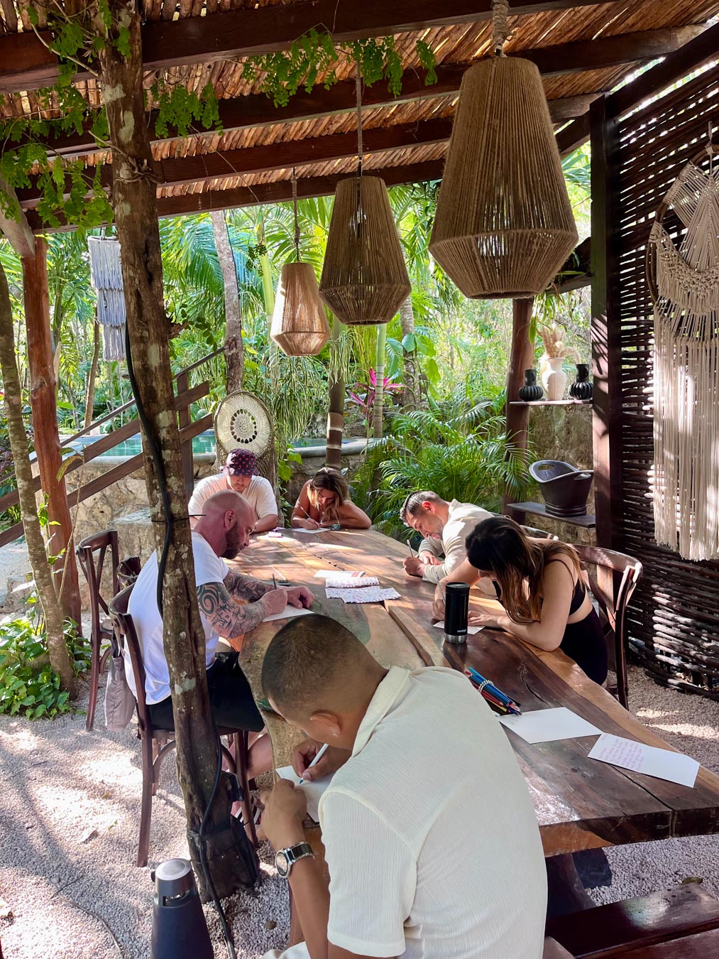 Retreat participants journaling together at Naum Tulum
